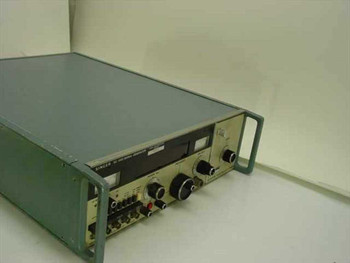 Singer SG-1000 Signal Generator and SG-1001 Frequency Extender side-angle view showing teal-green metal enclosure and front panel controls