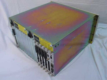 Racal-Datacom Excalibur Central Site chassis rear/side view showing installed card modules with V.35 connectors and yellow safety warning label