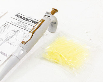 Hamilton SoftGrip 50µL pipette and Hamilton Single Channel Air Displacement Pipettes manual with bag of yellow Fisherbrand Sureone pipette tips