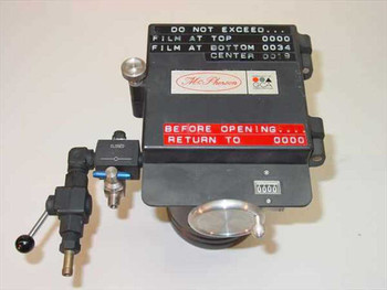 McPherson GCA film head assembly front view showing McPherson logo label, GCA badge, film position counter reading 0000, red warning label, and pneumatic valve assembly with lever