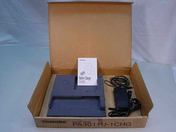 Toshiba PA3011U-1CHG battery charger open box with PA2450U AC adapter and manual – complete contents view