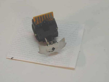 Prowriter 8510 9-pin dot matrix printhead assembly shown from above on a sheet of printed paper, with flex circuit connector visible at top