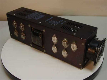 Microcomputer Power CP129 power supply – side view showing output transistors, transformer, and attached cooling fan with cracked housing