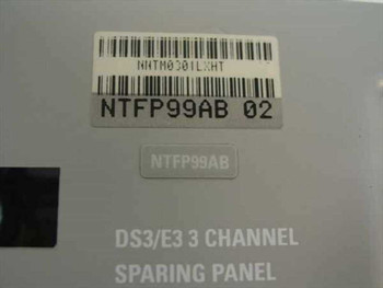 Nortel NTFP99AB DS3/E3 3-Channel Sparing Panel – close-up of label showing part number NTFP99AB 02, barcode NNTM0301LXHT, and embossed DS3/E3 3 Channel Sparing Panel text