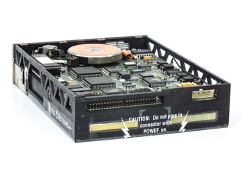 Iomega Beta 150A – rear/side view of drive interior showing PCB, caution label warning not to plug in connector with power on