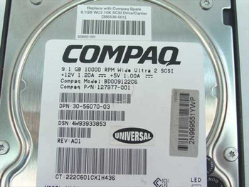 Compaq 127977-001 drive label close-up showing model BD009122C6, 9.1GB 10000 RPM Wide Ultra2 SCSI, +12V 1.20A +5V 1.00A, P/N 127977-001, REV A01
