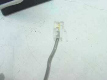 James Electronics 6607 AC Adapter RJ11 output plug close-up view on white surface