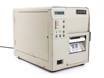 SATO M-8400 Industrial Barcode Label Printer front-right three-quarter view showing LCD display panel, indicator LEDs, and label exit slot with caution tag