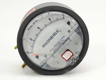 Dwyer 2008 Magnehelic differential pressure gauge front view showing 0-8 inches of water scale and red caution label