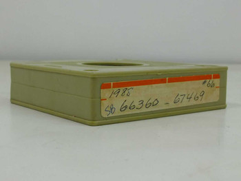 16mm microfilm cartridge in olive-green plastic housing — top view showing label dated 1985 with serial range Sb 66360-67469