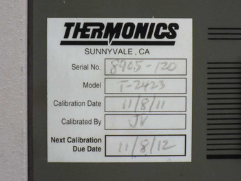 Thermonics T-2423 Precision Temperature Forcing System main console on casters with two T-ADF arm assemblies detached and lying on the floor in front