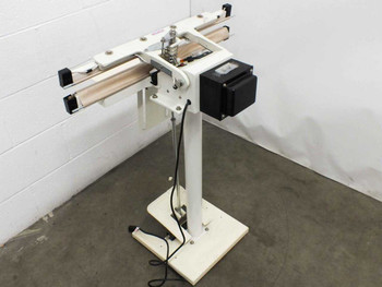 AIE W-600T heat sealer — rear three-quarter view showing transformer/control box, foot pedal cable, and stand base