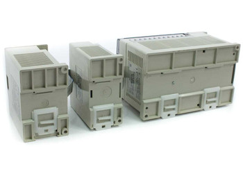 Mitsubishi FX2N-32MR-ES/UL, FX2N-8EYR, and FX2N-4DA modules — rear view showing DIN rail mounting clips and ventilation
