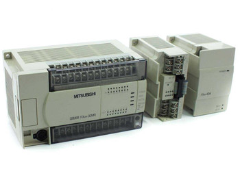 Mitsubishi FX2N-32MR-ES/UL PLC with FX2N-8EYR and FX2N-4DA expansion modules — front view showing all three units assembled
