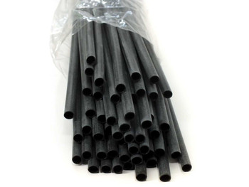 Close-up of black 3M EPS-300 dual-wall heat shrink tubing ends showing hollow cross-section
