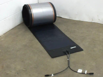 Uni-Solar PVL-136 136W flexible solar panel partially unrolled on floor with MC3 output cables visible