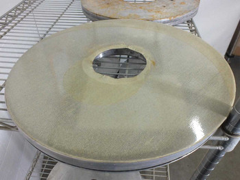 Close-up top view of a large 16-inch Lapmaster lapping plate with light green/cream abrasive surface and center bore