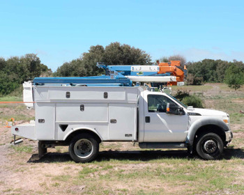 2013 Ford F550 4x4 bucket truck with Altec AT37G boom in stowed position — full driver-side profile view in field setting
