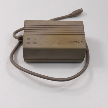 Compaq Series 2692 AC Adapter top-front view showing Compaq logo badge and attached multi-pin DIN output cable