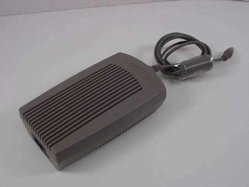 Compaq 261867-001 AC Adapter for Presario 1000 Series – top angled view showing ribbed gray housing and DC output cable