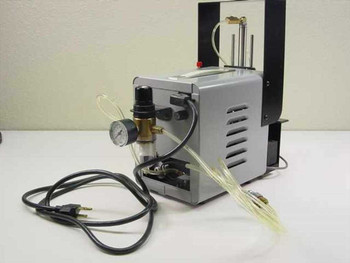 Ultramation OA-4 Pneumatic Linear Thruster — right side view showing silver compressor pump body, brass regulator/filter assembly, WIKA pressure gauge, and AC power cord