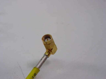Close-up of right-angle SMA male connector end on yellow semi-rigid RF coaxial cable