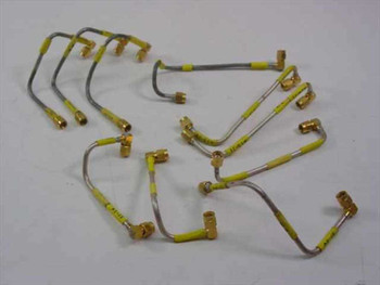 Lot of 10 yellow semi-rigid SMA male/male RF coaxial cables 6.5 inches long spread out showing right-angle connectors