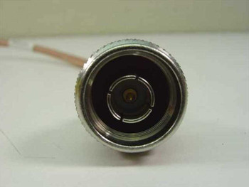 Close-up face-on view of N-Male connector end showing center pin and four-slot contact arrangement on ESM RG-400 coax cable