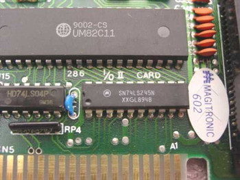 Close-up of Magitronic B231 ISA card PCB showing UMC UM82C11 main controller chip and Motorola SN74LS245N IC with board silkscreen reading 286 I/O II Card