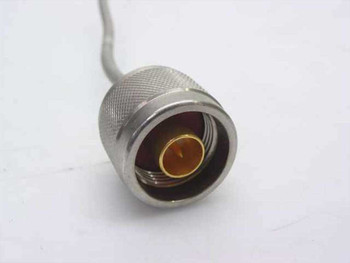 Close-up of N-type female bulkhead connector end of semi-rigid coaxial cable showing knurled metal body and center pin