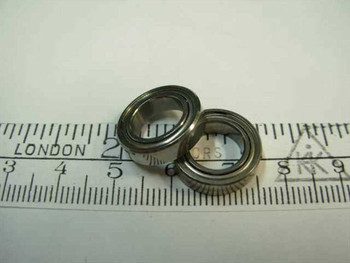 Steel double-shielded ball bearing 3/8 x 5/8 x 5/32 shown next to ruler for scale – top view of two bearings