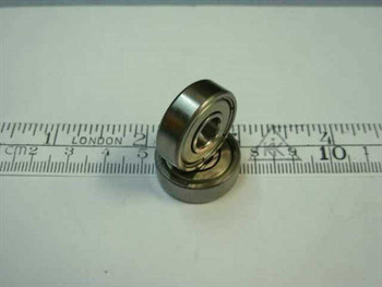627-2Z miniature double shielded ball bearing 7x22x7mm shown upright beside metric ruler — side profile view