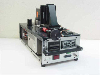EDC Exclusive Design Co 551A-DTS-05 Disk Test Fixture – right front three-quarter view showing spindle assembly, linear slide, and EDC front panel with DB-25 connector