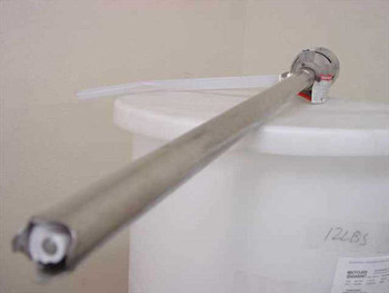 Grovbar M3 Universal Motor mounted on white plastic container showing stainless steel shaft and motor body, with handwritten 12LBS label visible
