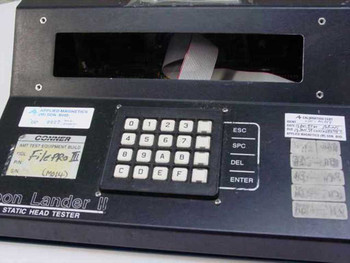 Conner Moon Lander II front panel showing hex keypad, ESC/SPC/DEL/ENTER keys, FilePro III label, and Applied Magnetics calibration stickers
