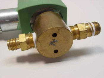 ASCO 8262G20 solenoid valve — close-up of brass valve body end showing two SAE flare outlet fittings and port face