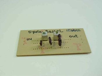 5-pole Bessel 15 MHz low pass filter hand-built on perforated PCB — top view showing IN and OUT SMA connectors and handwritten label