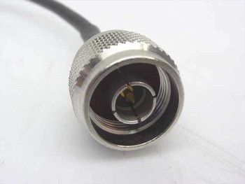 Close-up of TNC-M male connector end of RG-58/U coaxial cable showing nickel-plated knurled body and center pin