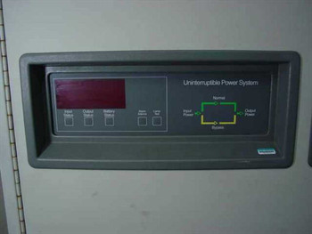 Emerson AP340 UPS – close-up of front control panel showing Uninterruptible Power System display with Input Status, Output Status, Battery Status indicators and power flow diagram