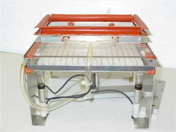UV discharge tube light frame with pneumatic lift — front three-quarter view showing aluminum frame, red silicone-sealed UV tube housing raised above base, and clear tubing