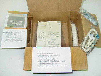 NEC NEAX 2400 ETJ1HM1 white single-line desktop telephone shown in open Qwest box with handset, cords, and programming speed dial guide