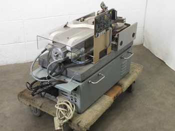 Guzik S1701 Spinstand — side and rear view showing electronics assembly, ribbon cables, and external power unit on pallet