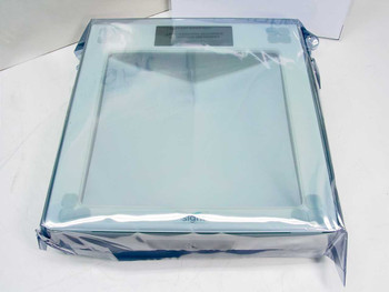Insight 1380 glass digital bathroom scale still sealed in clear plastic wrap, top view