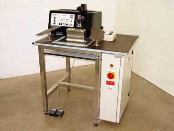 HyBond 616-12 Ultrasonic Peg Bonder full system view with stainless steel work table, X-Y stage, bonder head, and foot pedals on floor