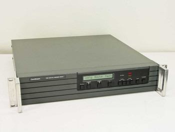 ComStream CM701 PSK Digital Modem front panel and full chassis — 2U rackmount with LCD display showing Config Monitor Faults menu