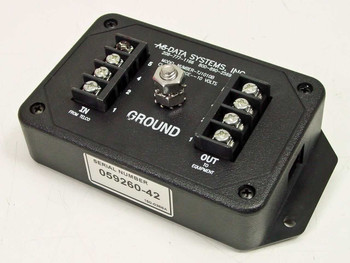 AC Data Systems TJ1010B surge suppressor – top view showing IN from telco and OUT to equipment terminal blocks, central ground stud, and serial number label 059260-42