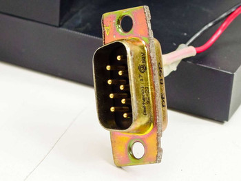 Close-up of DB9 male 9-pin D-sub connector on electronic shutter assembly with red and gray wiring leads visible