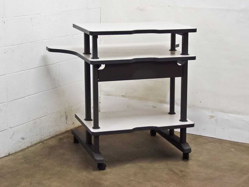 3-tier mobile computer desk — right-front angle view showing shelf tiers, steel posts, and rolling casters