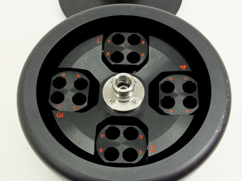 Tomy TMS-4 centrifuge rotor interior showing 4 swing buckets each with 4 tube positions numbered in red, stainless hub