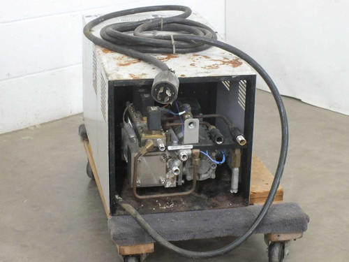 Matsui MCM-151 temperature controller rear/side view with panel open showing Speck Pumpen pump assembly, hydraulic manifold, valves, and heavy-gauge power cable coiled on top; rust evident on enclosure exterior